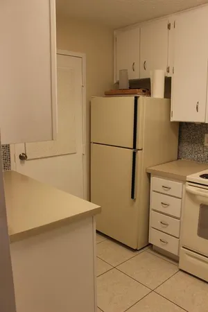 a white refrigerator freezer sitting in a kitchen