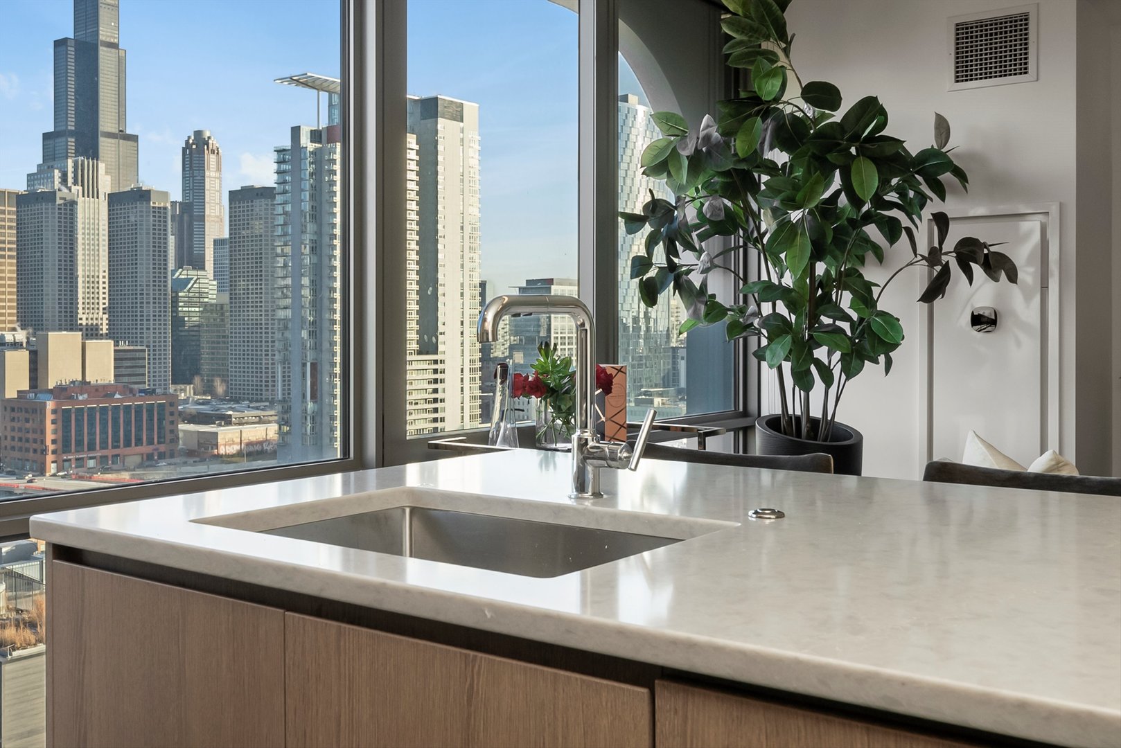 164 North Peoria Street, Unit 1705 Chicago, IL 60607 - Photo 21 of 33 a kitchen with a sink and a potted plant