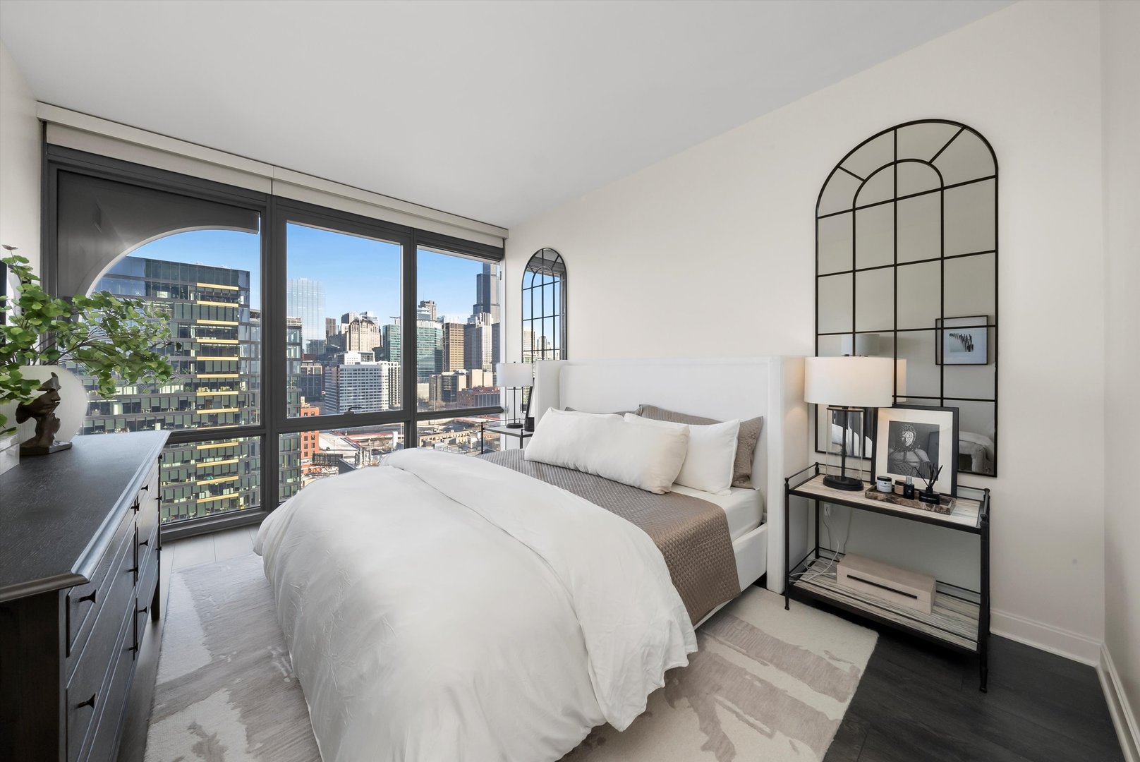 164 North Peoria Street, Unit 1705 Chicago, IL 60607 - Photo 4 of 33 a bedroom with a large bed and a chandelier