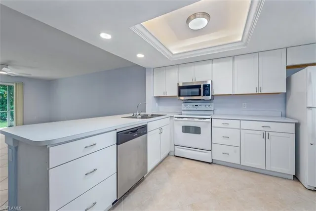 a kitchen with cabinets stainless steel appliances and counter space