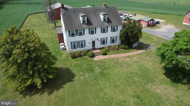 a view of a big room with a big yard and large trees