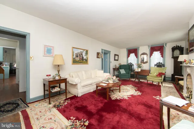 a view of a workspace with furniture and a book shelf
