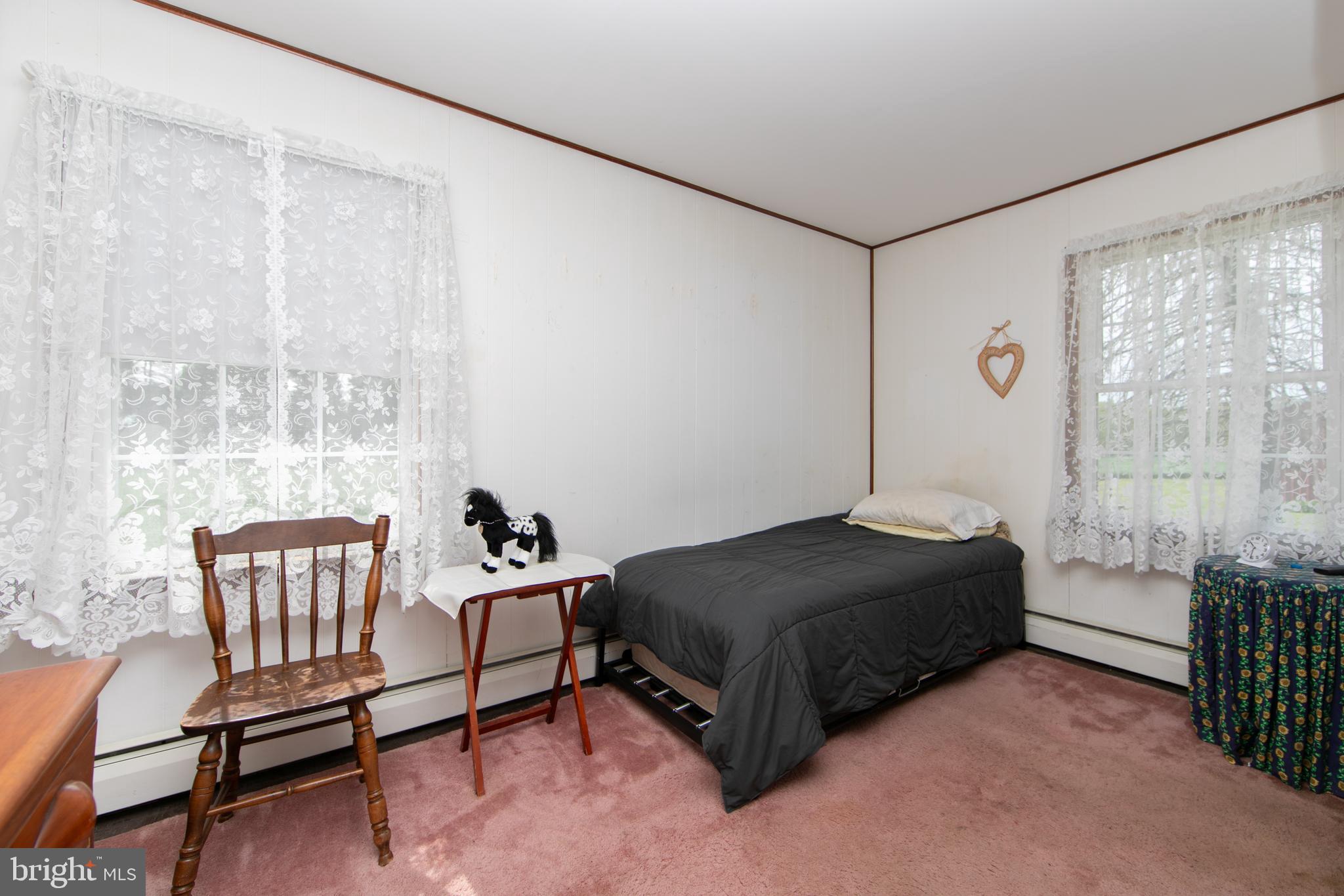 111 Newbolds Corner Road Southampton, NJ 08088 - Photo 37 of 96 a bedroom with a bed and a chair in it