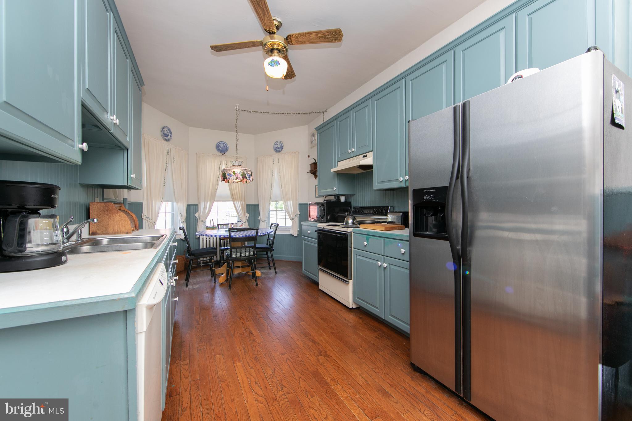 111 Newbolds Corner Road Southampton, NJ 08088 - Photo 40 of 96 a kitchen with stainless steel appliances a refrigerator a sink dishwasher a stove and a dining table with wooden floor