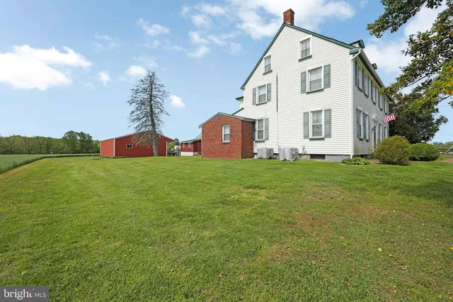 a view of a house with a yard and furniture