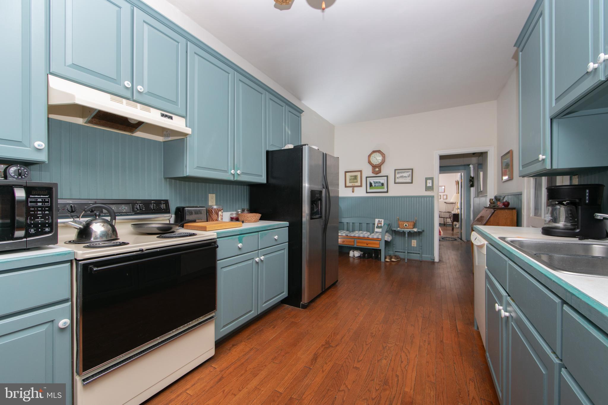 111 Newbolds Corner Road Southampton, NJ 08088 - Photo 42 of 96 a kitchen with stainless steel appliances granite countertop a refrigerator a sink dishwasher a stove and white countertops with wooden floor