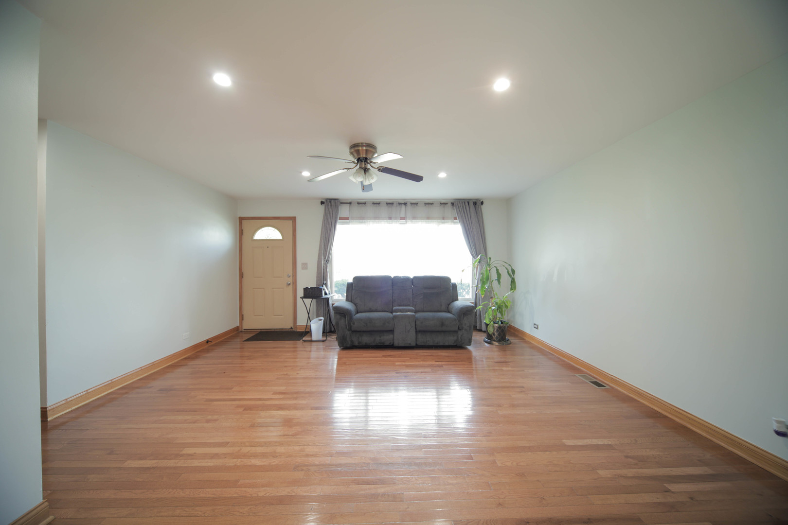 543 Rose Avenue Addison, IL 60101 - Photo 6 of 18 wooden floor in an empty room with a window
