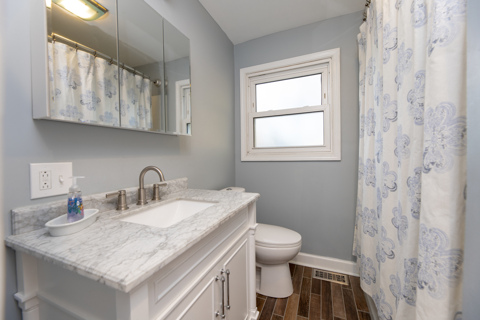543 Rose Avenue Addison, IL 60101 - Photo 7 of 18 a bathroom with a granite countertop sink a toilet and a mirror
