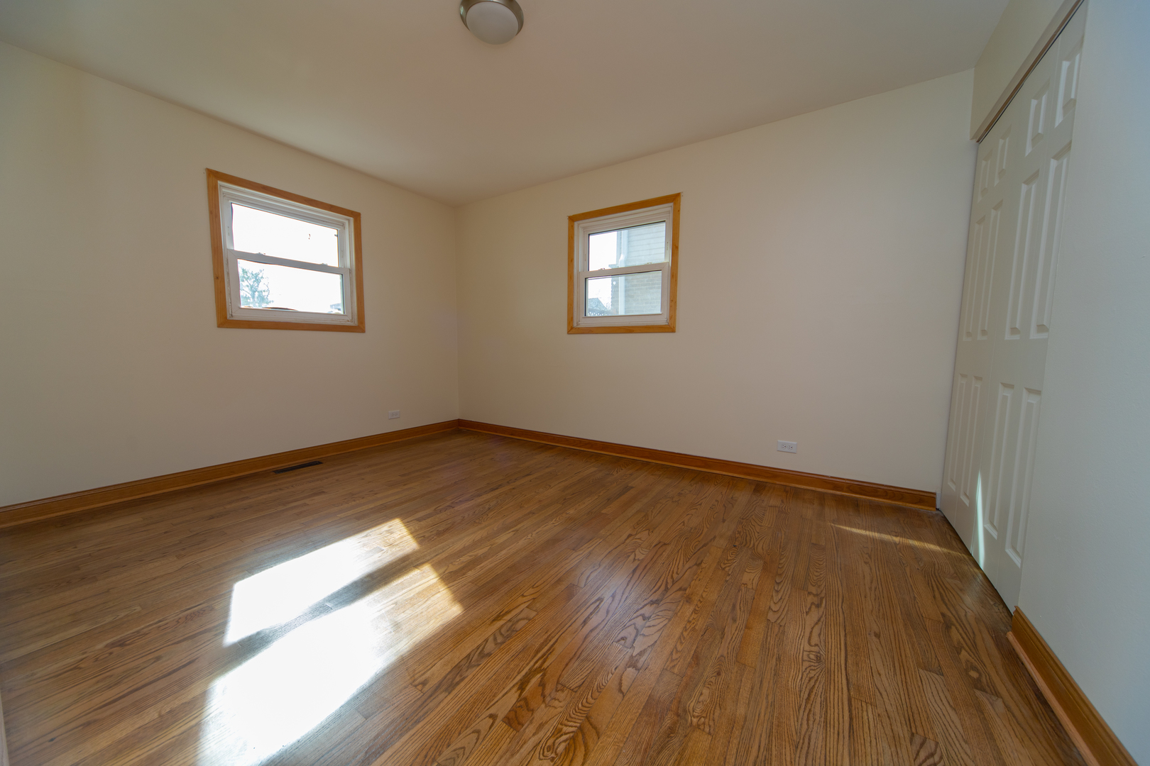 543 Rose Avenue Addison, IL 60101 - Photo 9 of 18 a view of empty room with wooden floor and fan