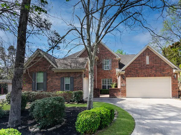 a front view of a house with a garden and plants
