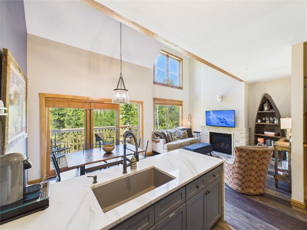 a very nice looking living room with a large window and a fireplace