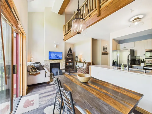 a living room with fireplace furniture and a chandelier