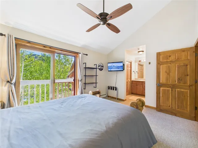 a bedroom with a large bed and a large window