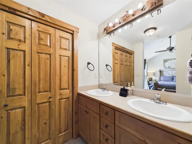 a bathroom with double vanity sinks and a mirror
