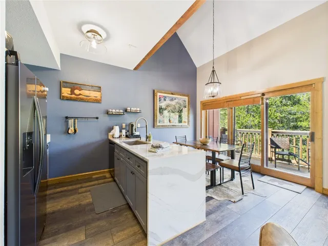 a view of a kitchen with furniture wooden floor and windows