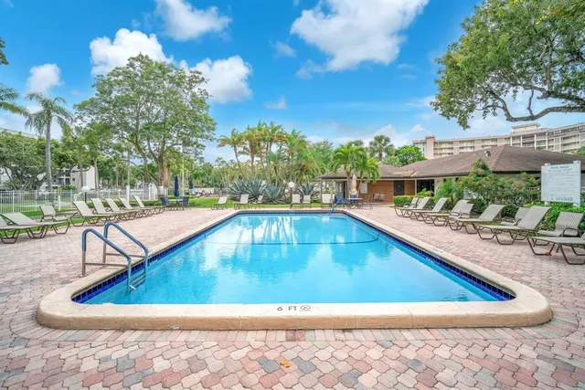 a view of a park with trees in the background