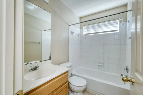 an empty room with chandelier fan