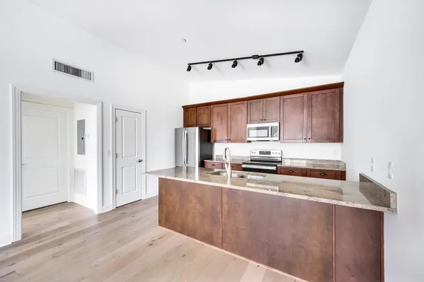 a kitchen with stainless steel appliances a sink and cabinets