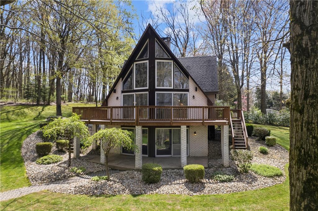 This A-frame, chalet-style home makes an unforgettable first impression with its soaring wall of windows and connection to nature. Nestled among the trees, it feels peaceful and private—offering a serene backdrop whether you’re settling in full-time or escaping for the weekend