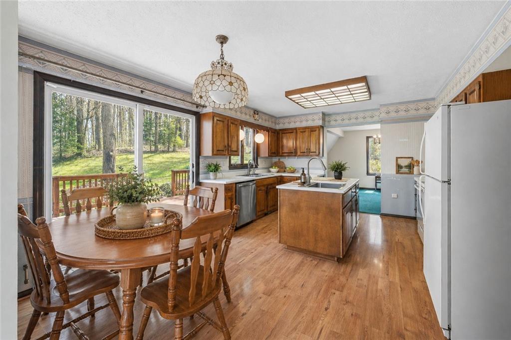 255 Claytonia Road Butler, PA 16001 - Photo 17 of 50 VIRTUALLY STAGED- Charming farmhouse-style kitchen with solid wood cabinetry, a center island, and a simple, inviting feel—imagine slow weekend mornings filled with the smell of coffee brewing and breakfast cooking as natural light pours in.
