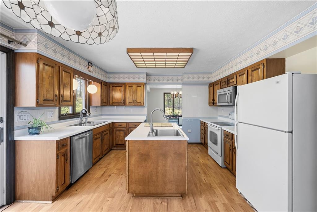 255 Claytonia Road Butler, PA 16001 - Photo 19 of 50 Charming farmhouse-style eat-in kitchen with solid wood cabinetry, a center island, and a classic, inviting feel—imagine slow weekend mornings filled with the smell of coffee brewing and breakfast cooking as natural light pours in.