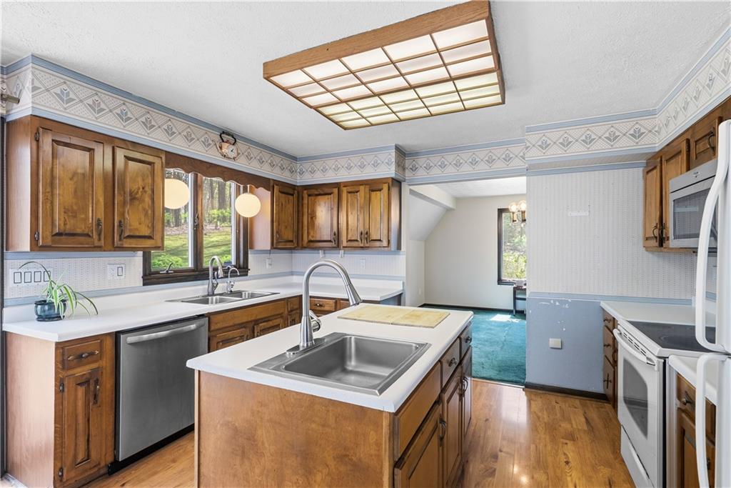 255 Claytonia Road Butler, PA 16001 - Photo 20 of 50 Charming farmhouse-style eat-in kitchen with solid wood cabinetry, a center island, and a classic, inviting feel—imagine slow weekend mornings filled with the smell of coffee brewing and breakfast cooking as natural light pours in.