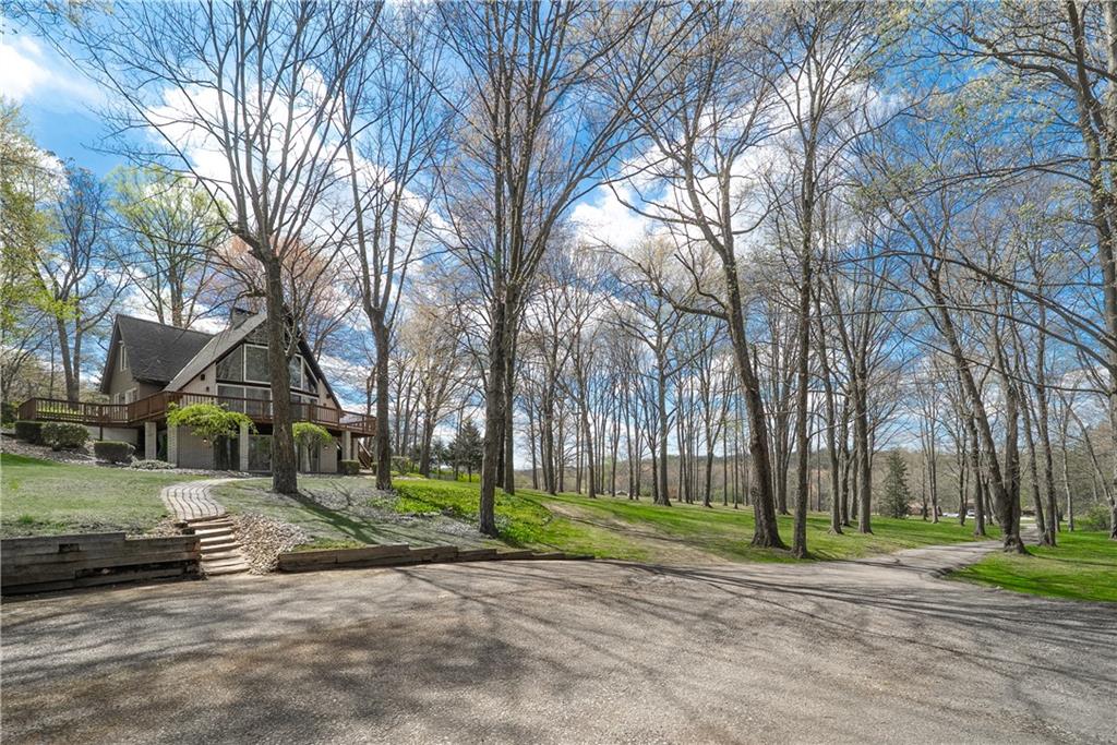 255 Claytonia Road Butler, PA 16001 - Photo 2 of 50 Tucked behind a long private driveway, this home is completely enveloped by trees, offering a rare sense of seclusion and serenity. With ample space for parking and guests, it’s the kind of setting where you can truly unwind, unplug, and enjoy the quiet—whether as your private everyday residence or a peaceful family weekend retreat