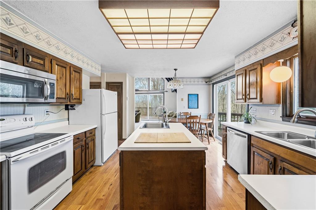 255 Claytonia Road Butler, PA 16001 - Photo 21 of 50 Charming farmhouse-style eat-in kitchen with solid wood cabinetry, a center island, and a classic, inviting feel—imagine slow weekend mornings filled with the smell of coffee brewing and breakfast cooking as natural light pours in.