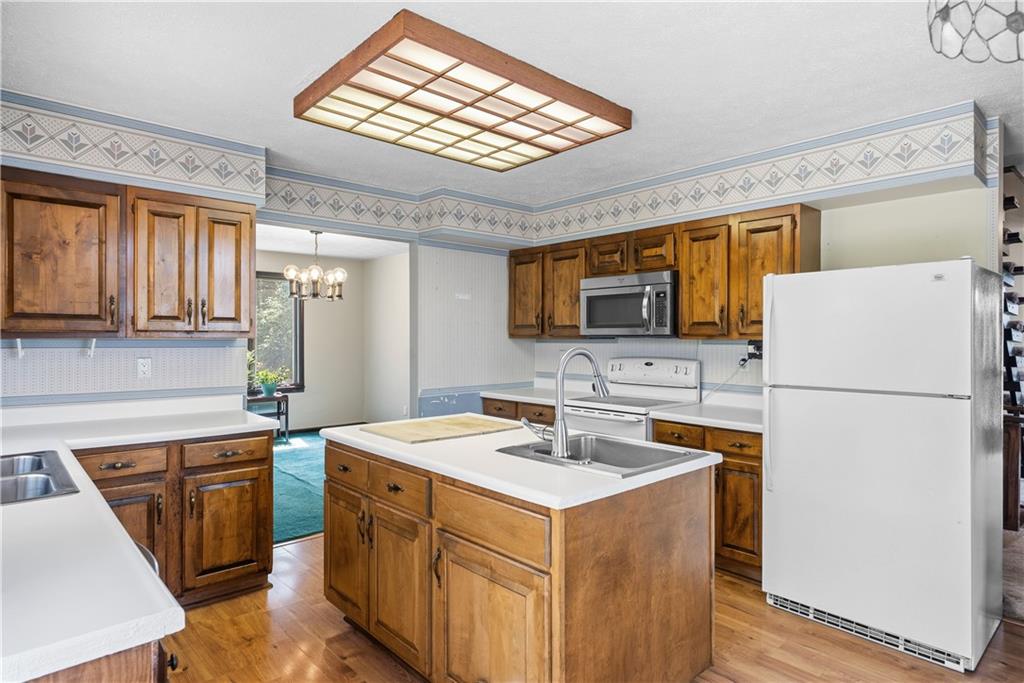 255 Claytonia Road Butler, PA 16001 - Photo 22 of 50 Charming farmhouse-style eat-in kitchen with solid wood cabinetry, a center island, and a classic, inviting feel—imagine slow weekend mornings filled with the smell of coffee brewing and breakfast cooking as natural light pours in.