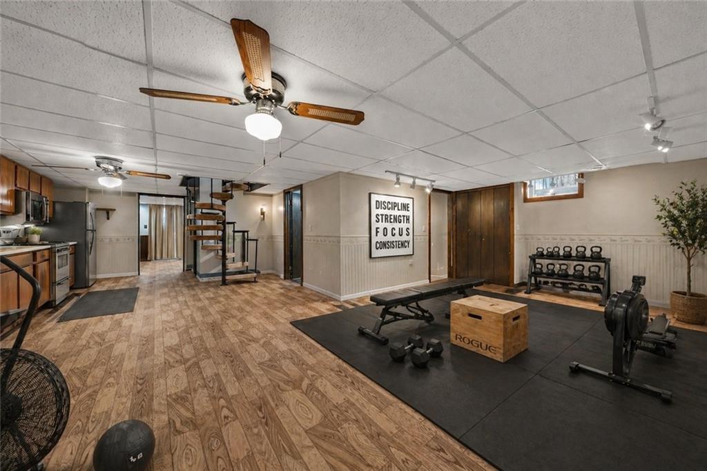 255 Claytonia Road Butler, PA 16001 - Photo 43 of 50 VIRTUALLY STAGED as a private fitness retreat, this expansive lower level easily transforms into a fully equipped home gym. With ample open space for strength training, cardio, and functional workouts, it’s the perfect setup for daily routines without ever leaving home. The adjacent secondary kitchen adds convenience for hydration, meal prep, or post-workout recovery—bringing both function and lifestyle together in one space
