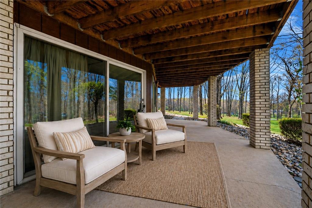 255 Claytonia Road Butler, PA 16001 - Photo 47 of 50 VIRTUALLY STAGED-lJust off the finished game room, the lower-level deck extends your living space outdoors—an ideal spot to unwind, host guests, or simply soak in the serenity of the surrounding trees.
