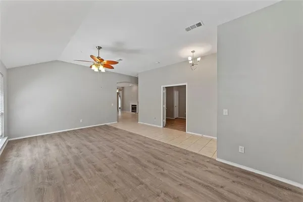 a view of an empty room and wooden floor