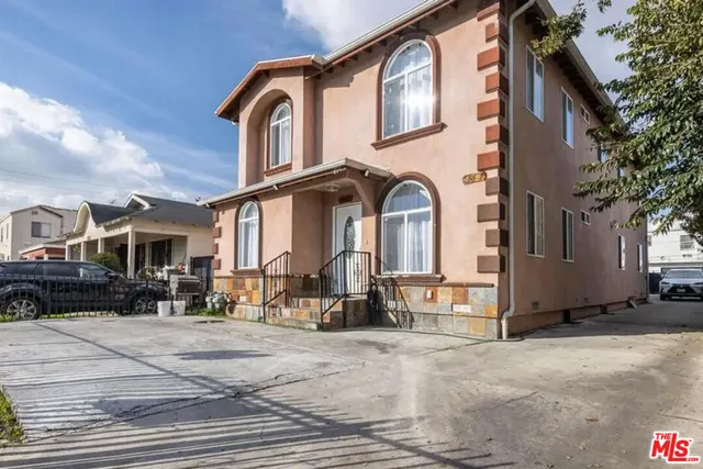 a view of a brick house with large windows