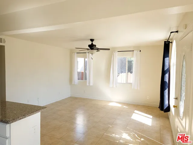 a view of a room with a refrigerator and a window