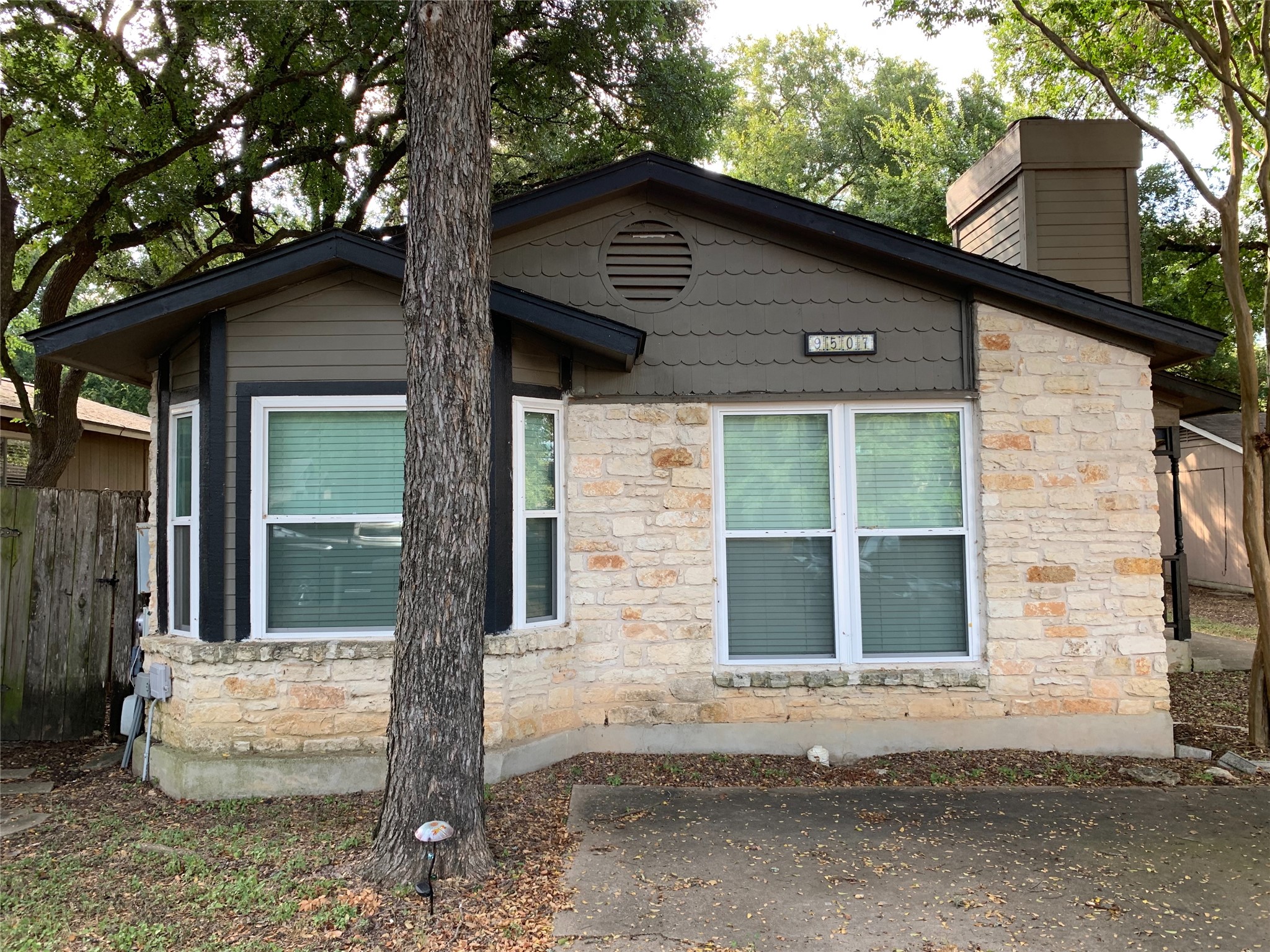9507 Nightjar Drive, Unit B Austin, TX 78748 - Photo 1 of 1 View of side of property featuring stone siding and fence
