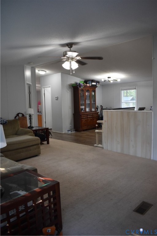 26049 Guy Place Road Courtland, VA 23837 - Photo 7 of 24 Carpeted main living area featuring a ceiling fan