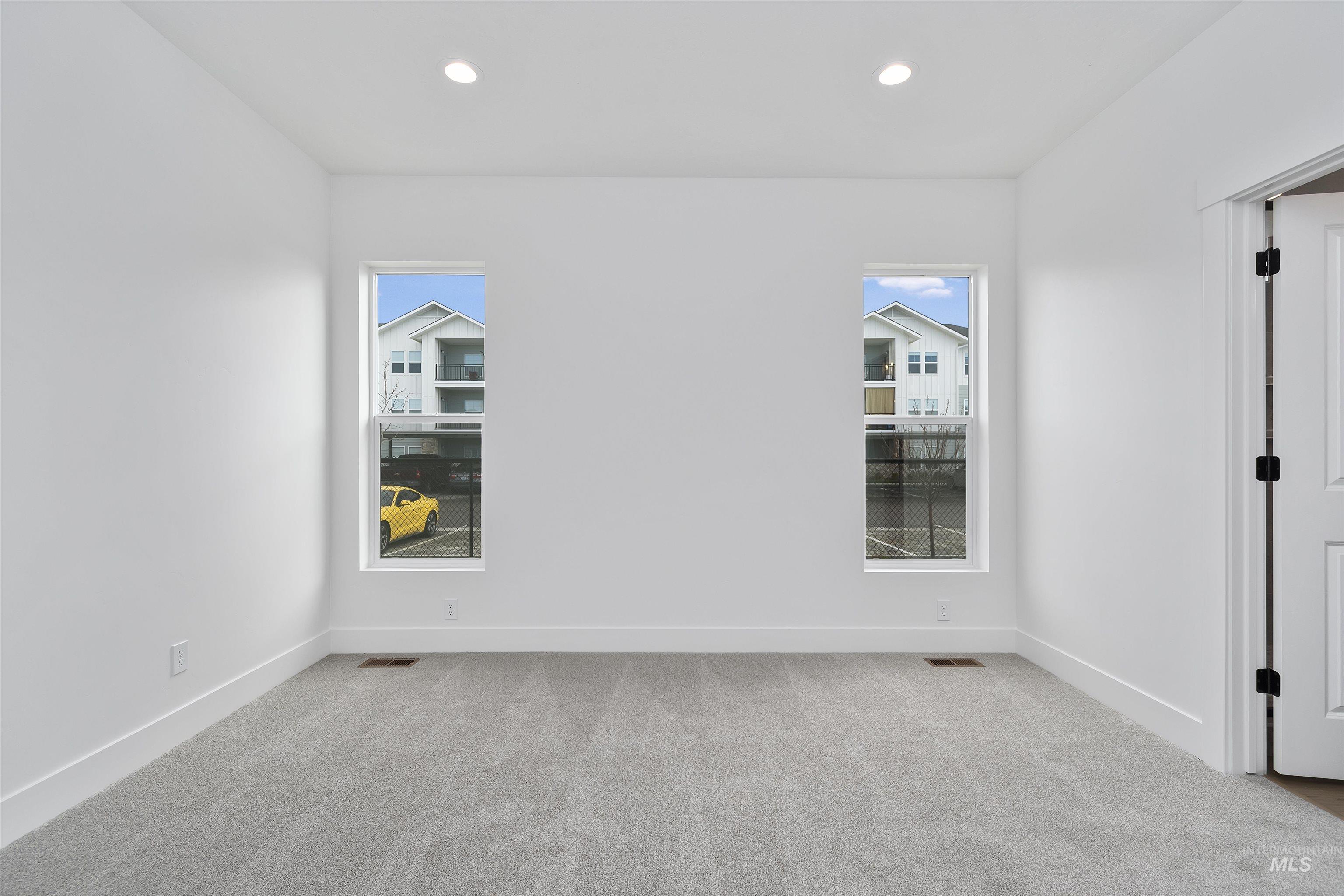 732 South Calhoun Lane Star, ID 83669 - Photo 18 of 48 Empty room featuring light colored carpet, healthy amount of natural light, and recessed lighting