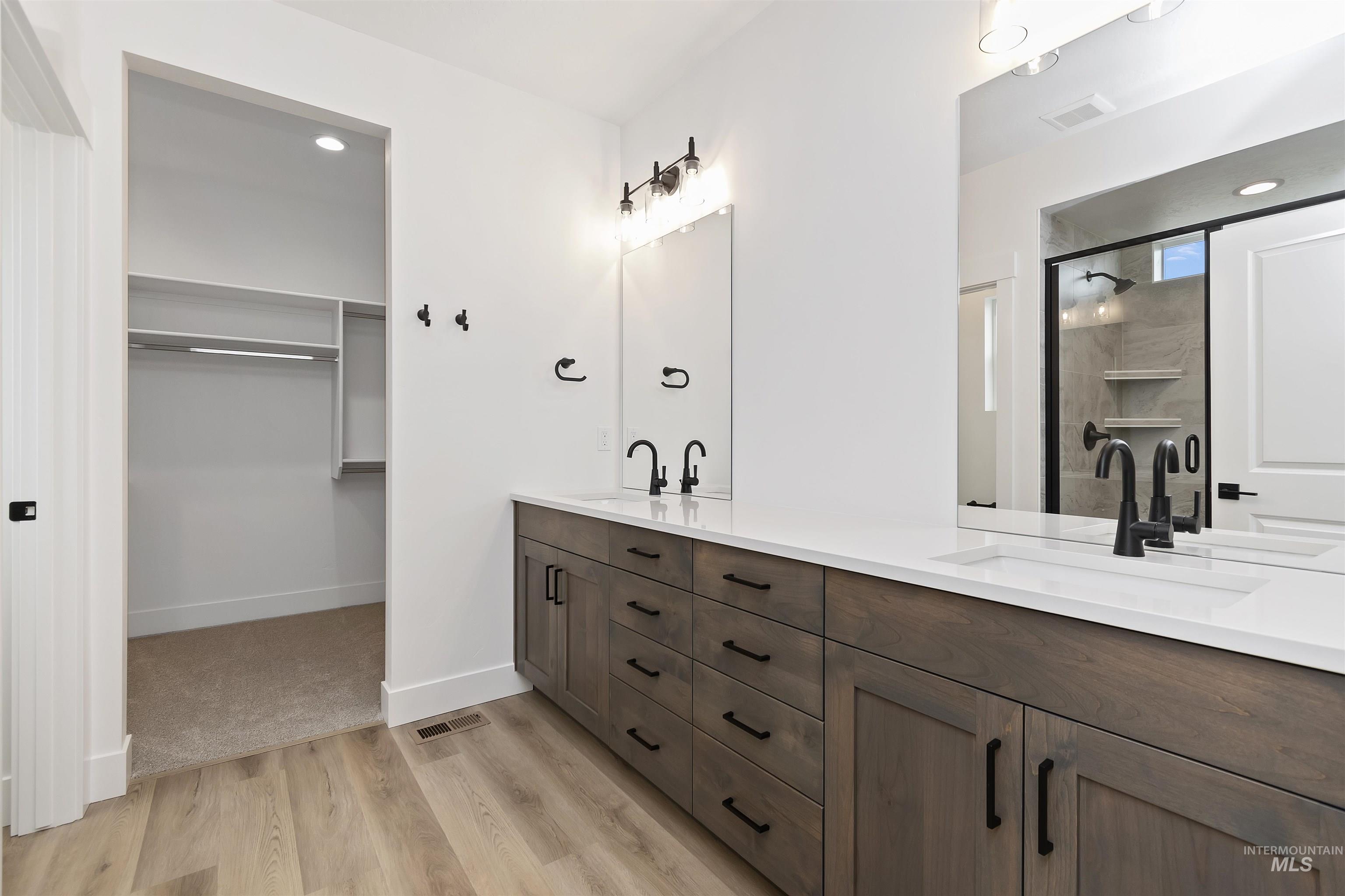 732 South Calhoun Lane Star, ID 83669 - Photo 19 of 48 Full bathroom featuring a shower stall, double vanity, a walk in closet, light wood finished floors, and recessed lighting