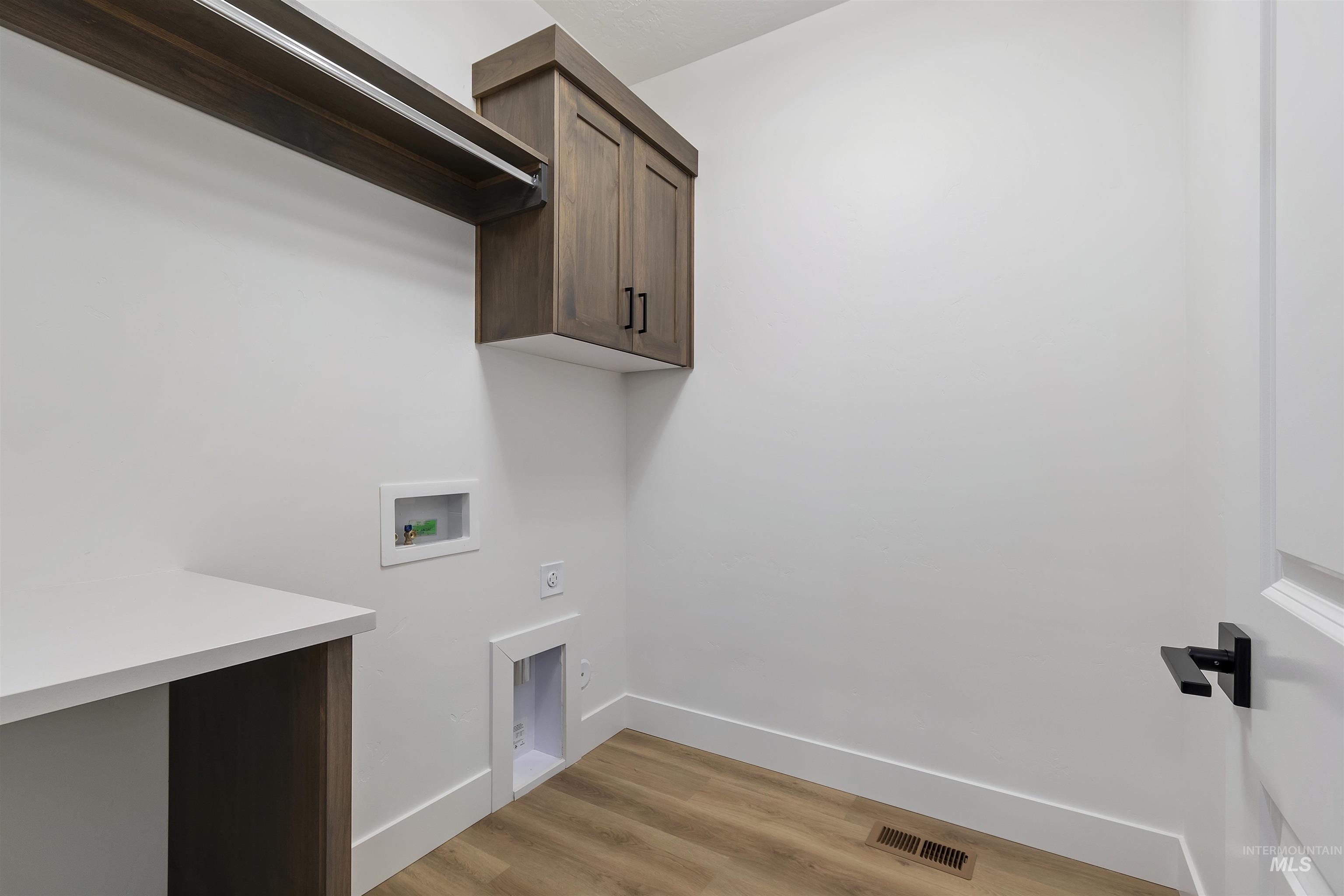 732 South Calhoun Lane Star, ID 83669 - Photo 19 of 50 Washroom featuring light wood-type flooring, hookup for a washing machine, and electric dryer hookup