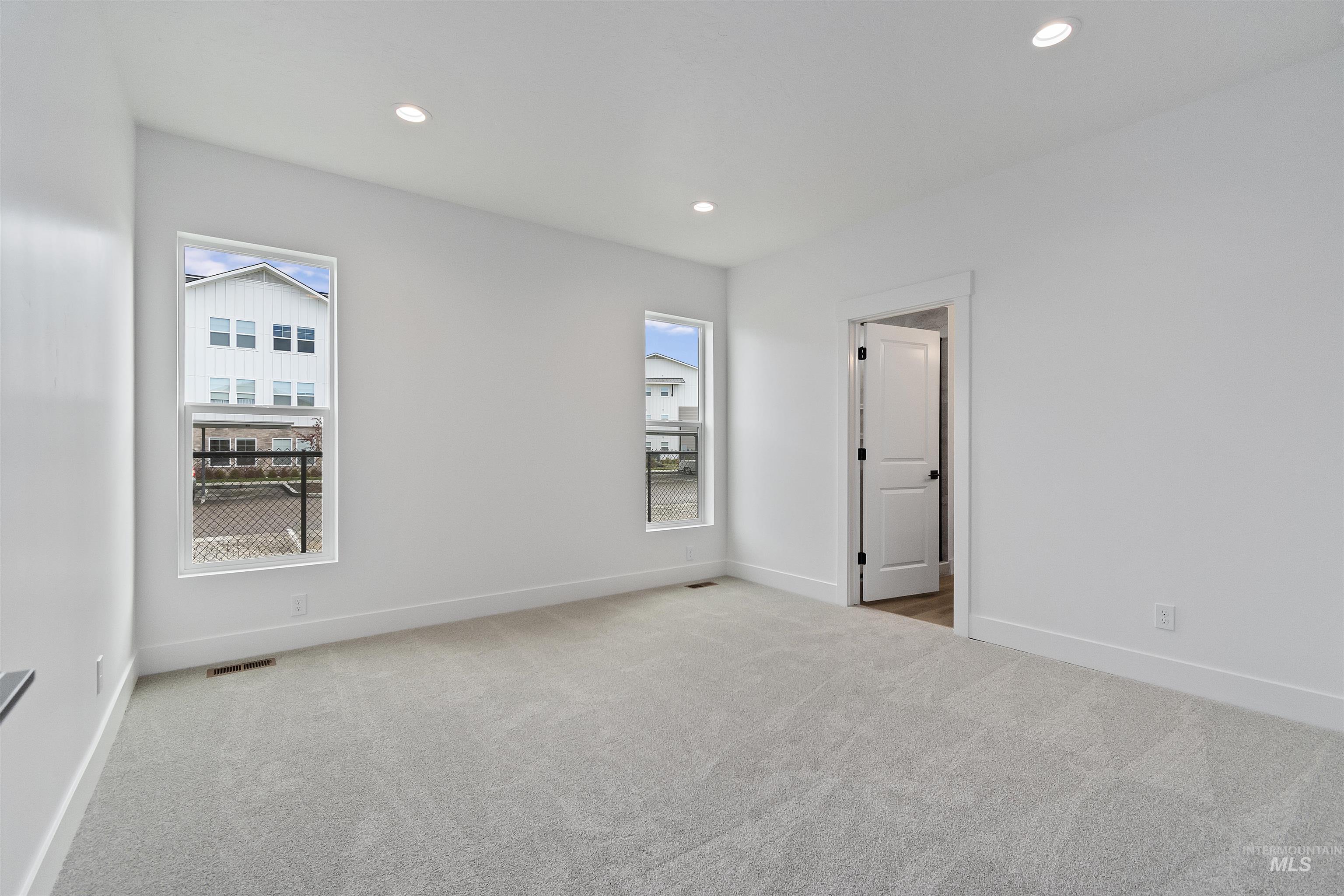 732 South Calhoun Lane Star, ID 83669 - Photo 23 of 50 Empty room with light carpet and recessed lighting