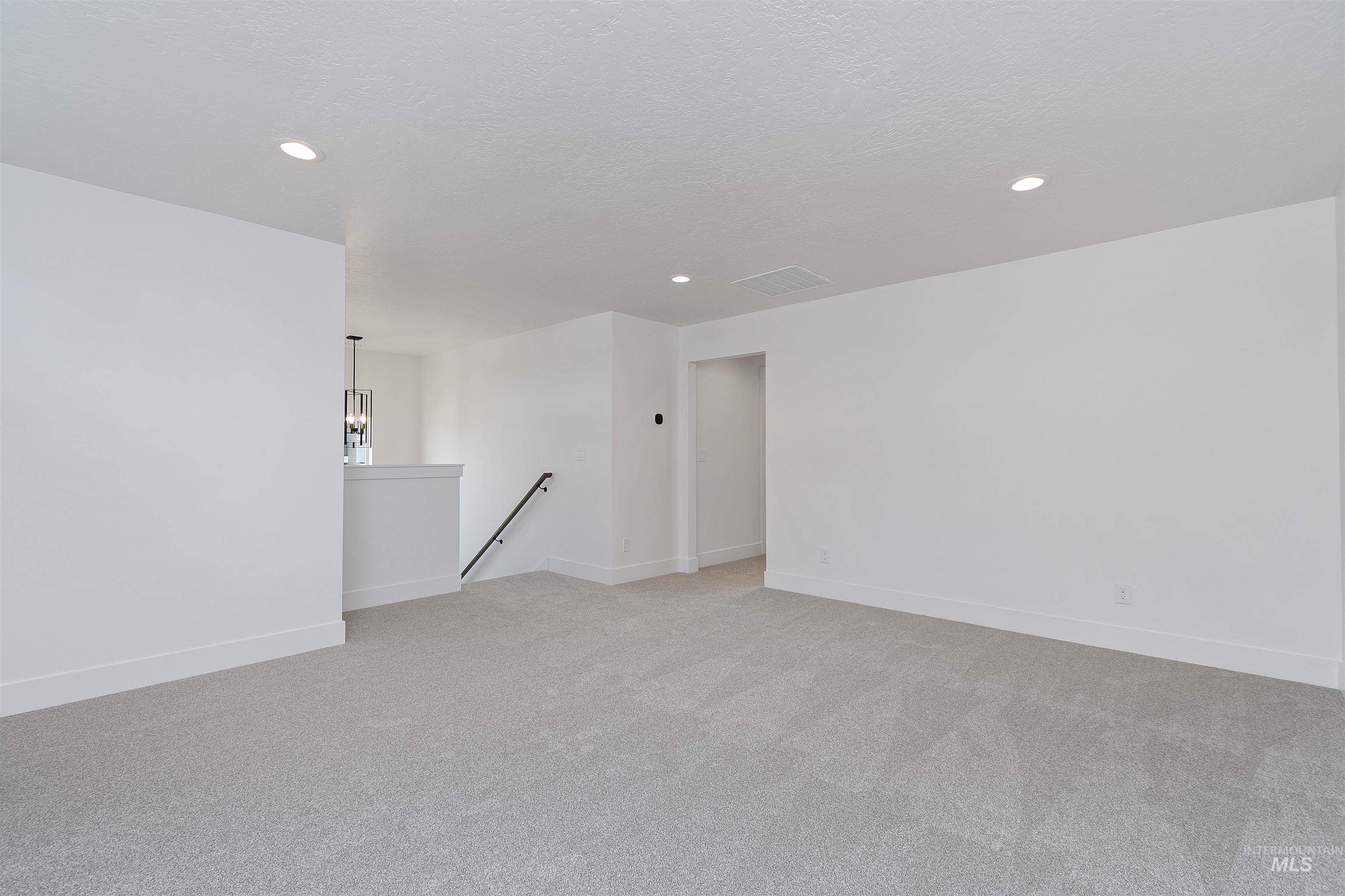 732 South Calhoun Lane Star, ID 83669 - Photo 28 of 50 Empty room with light colored carpet, recessed lighting, and a textured ceiling