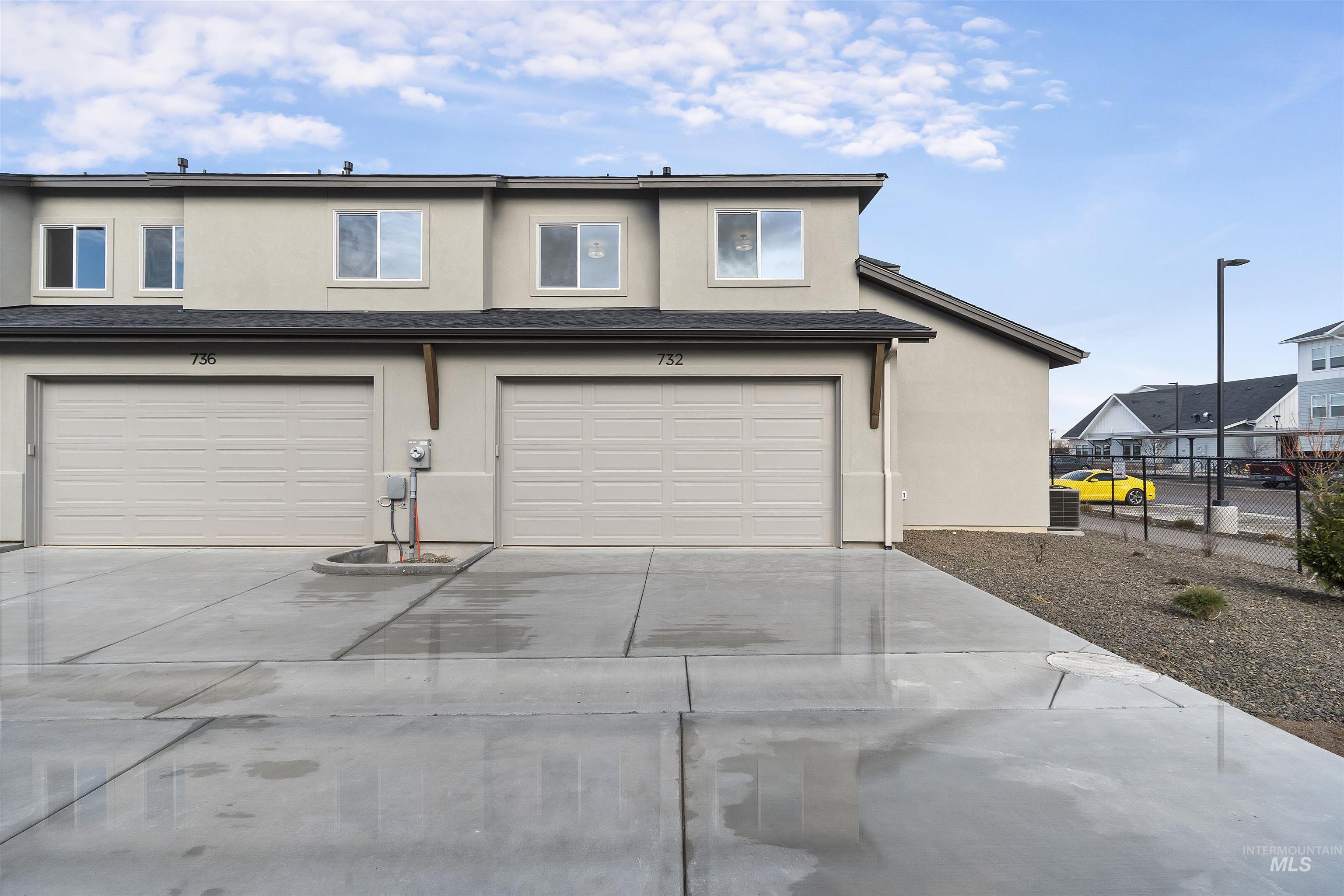 732 South Calhoun Lane Star, ID 83669 - Photo 38 of 48 View of back of property with stucco siding, driveway, and a garage