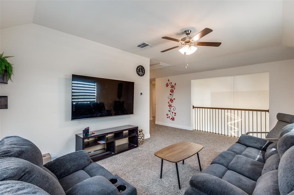 7636 Cherry Blossom Lane Little Elm, TX 76227 - Photo 10 of 31 a living room with furniture and a flat screen tv
