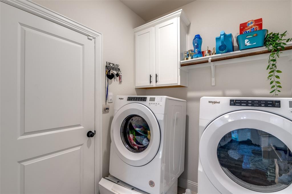 7636 Cherry Blossom Lane Little Elm, TX 76227 - Photo 11 of 31 a utility room with dryer and washer