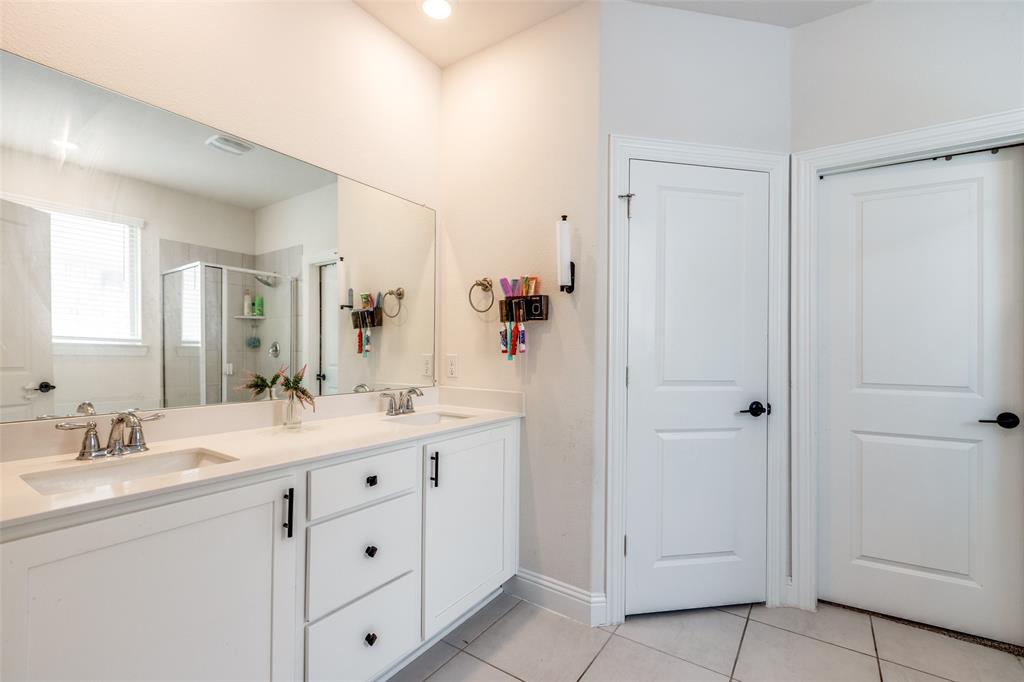 7636 Cherry Blossom Lane Little Elm, TX 76227 - Photo 13 of 31 a spacious bathroom with a double vanity sink mirror and