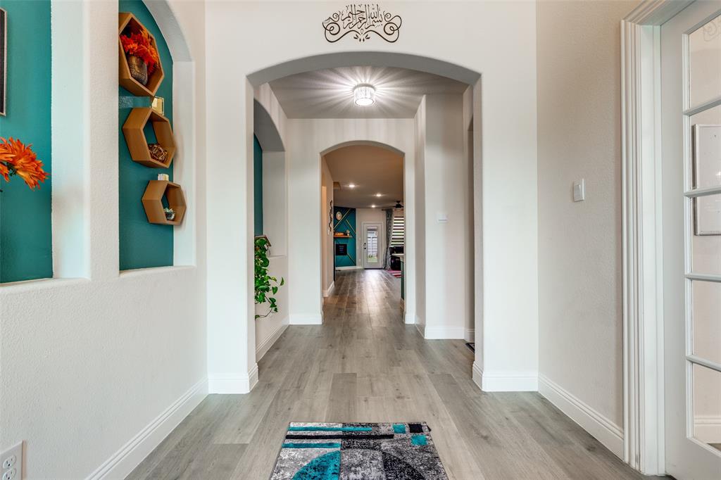 7636 Cherry Blossom Lane Little Elm, TX 76227 - Photo 2 of 31 wooden floor in a hall with an entryway and wooden floor