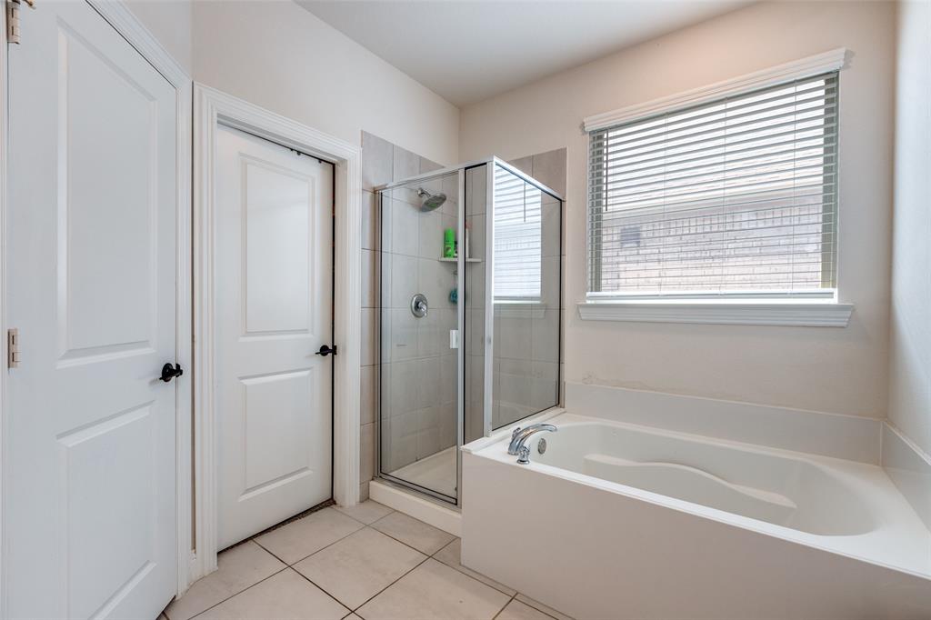 7636 Cherry Blossom Lane Little Elm, TX 76227 - Photo 20 of 31 a bathroom with a bathtub and a shower
