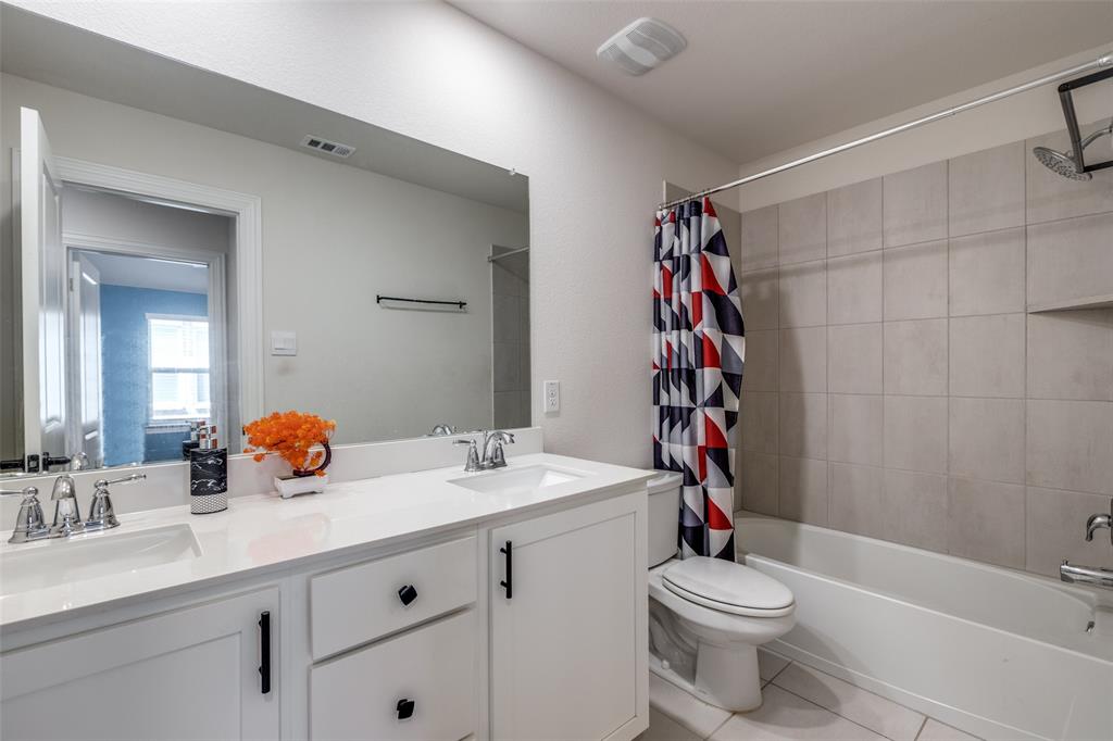 7636 Cherry Blossom Lane Little Elm, TX 76227 - Photo 21 of 31 a bathroom with a sink a toilet and shower