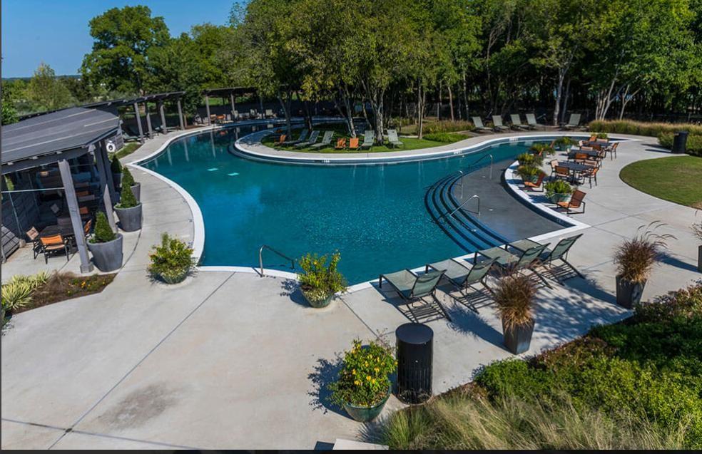 7636 Cherry Blossom Lane Little Elm, TX 76227 - Photo 26 of 31 a view of a swimming pool with a patio and a fire pit