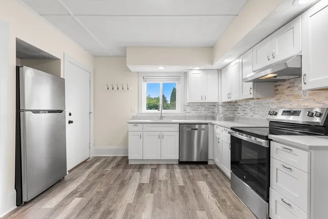 a kitchen with a sink stove and refrigerator